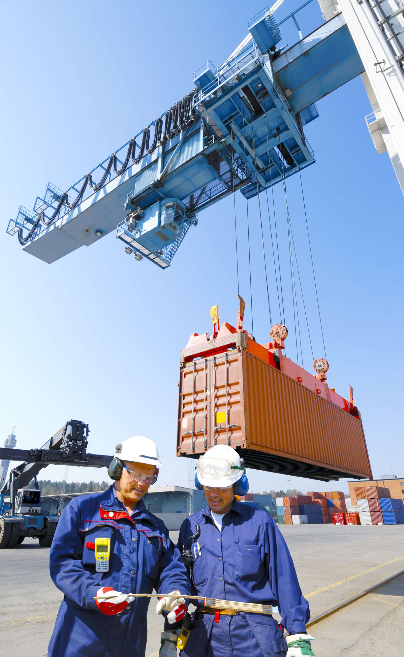 Workers in commercial port, container-crane and truck