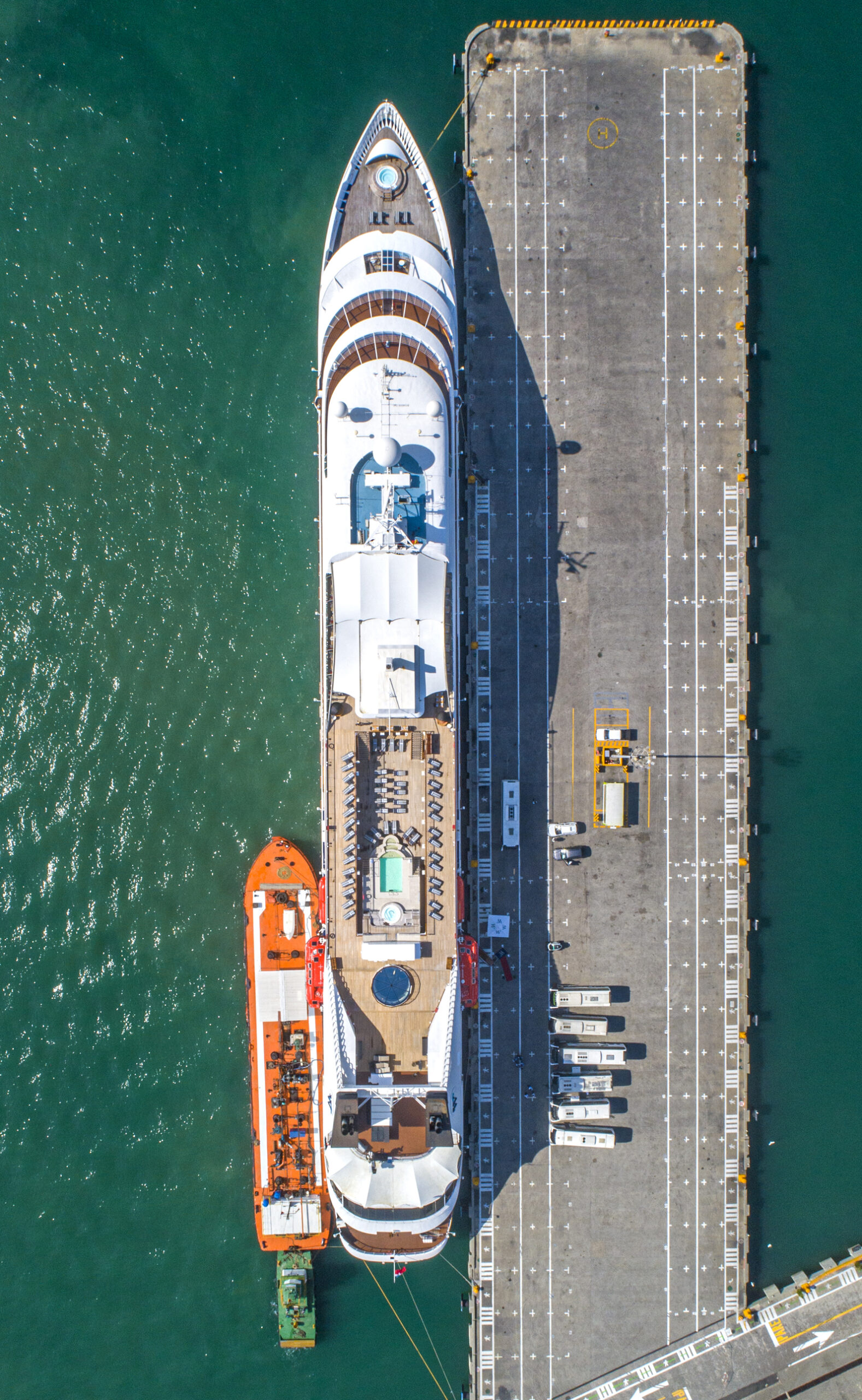 Workers in commercial port, container-crane and truck
